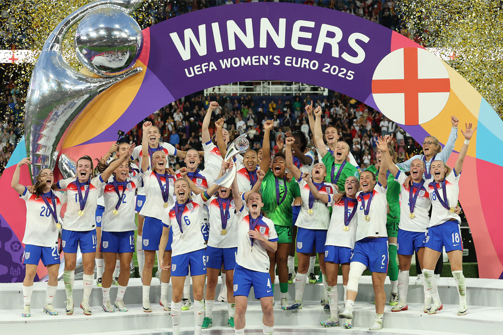 ```
Women football winners celebrating under arch. Spartan Property Estate Agents supports champions in every field.
```