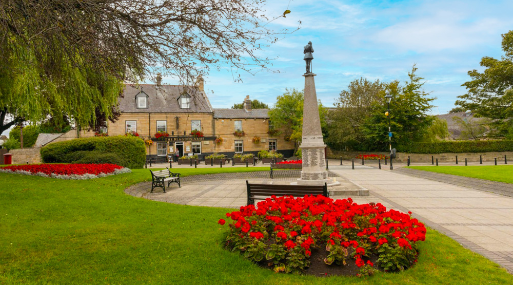 Charming town square with a monument and gardens near Spartan Property Estate Agents' featured listings.